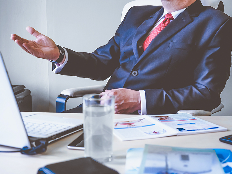 Marketing guy in blazer over his desk