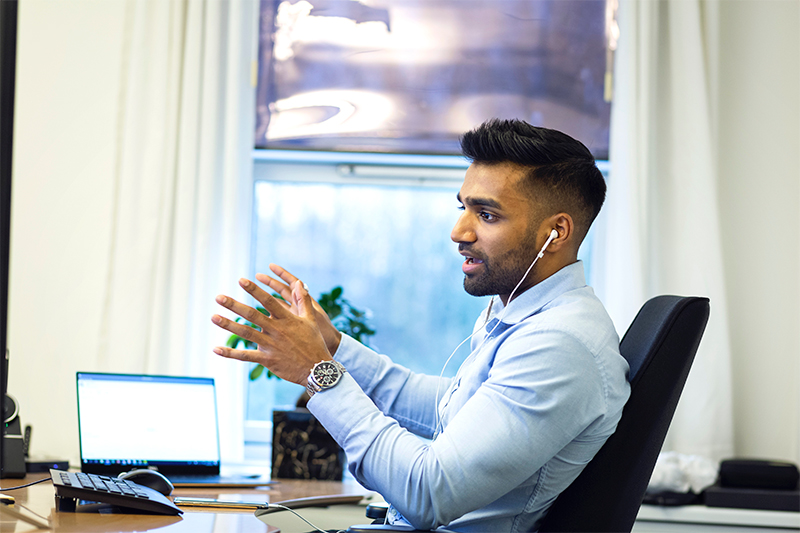 Guy in office talking to client over a video/audio call